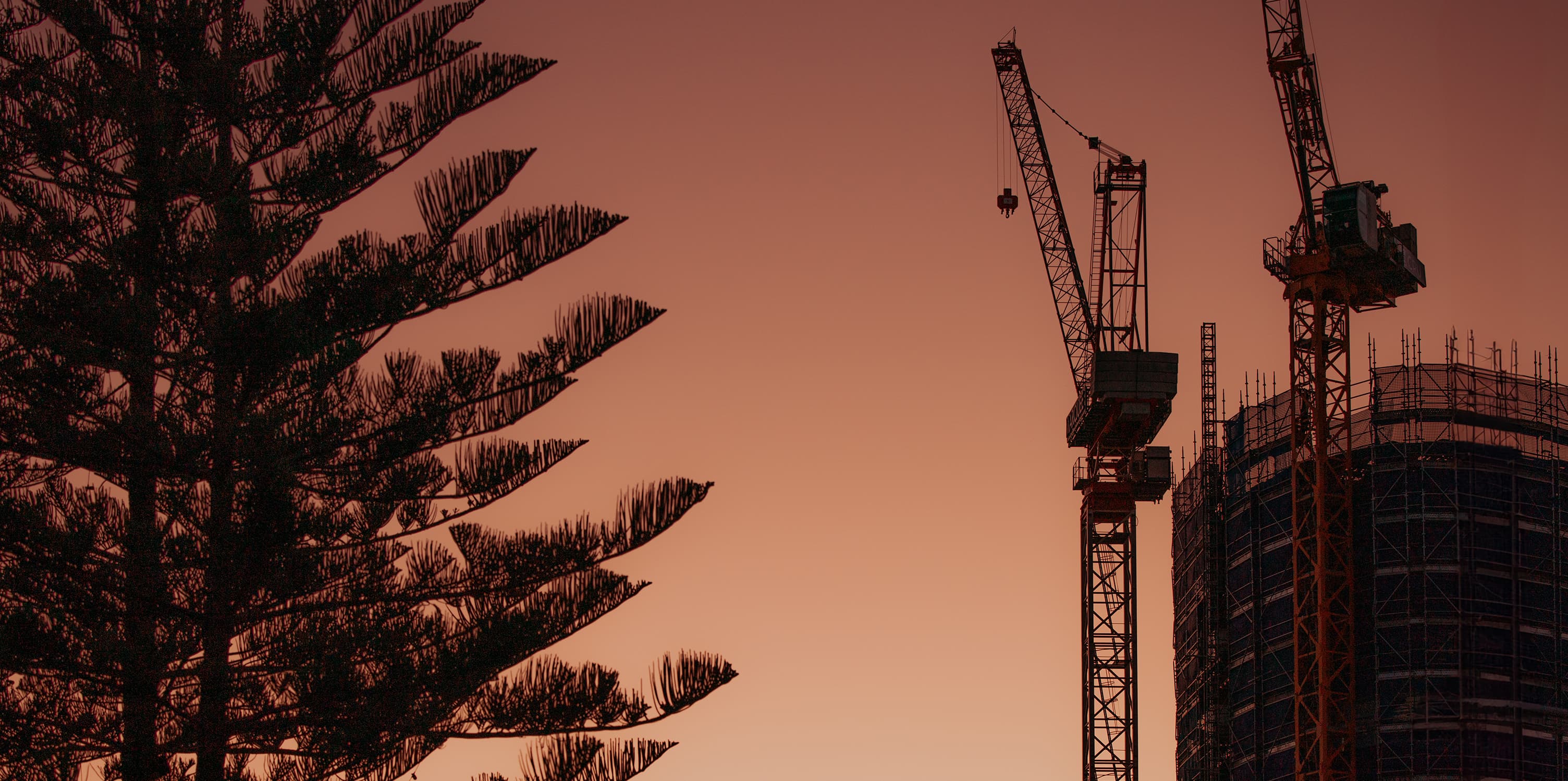 Two cranes constructing a building on the Gold Coast.